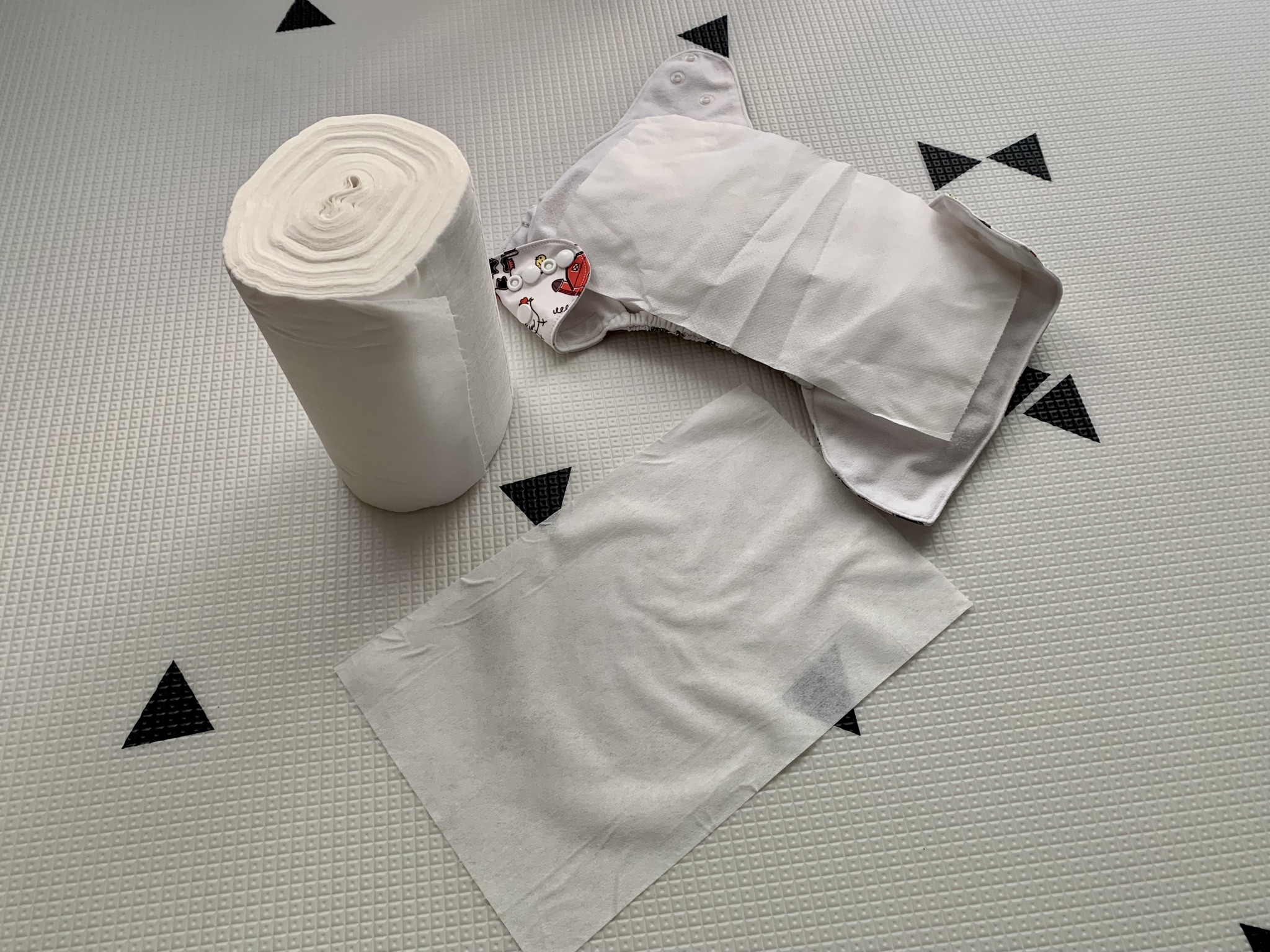 Diaper liner roll with liner on diaper